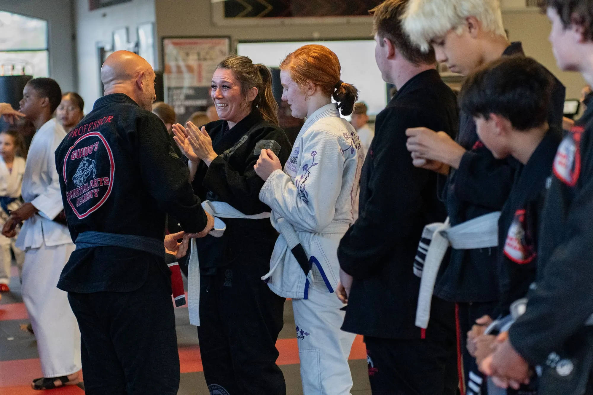 Teen and adult students with their certified instructor team after a belt promotion at Guido's Martial Arts Academy in Clovis