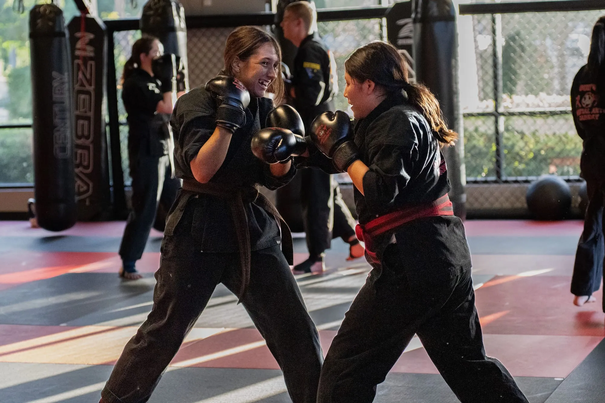 Adult woman training Brazilian Jiu-Jitsu in the dojo at Guido's Martial Arts Academy in Clovis