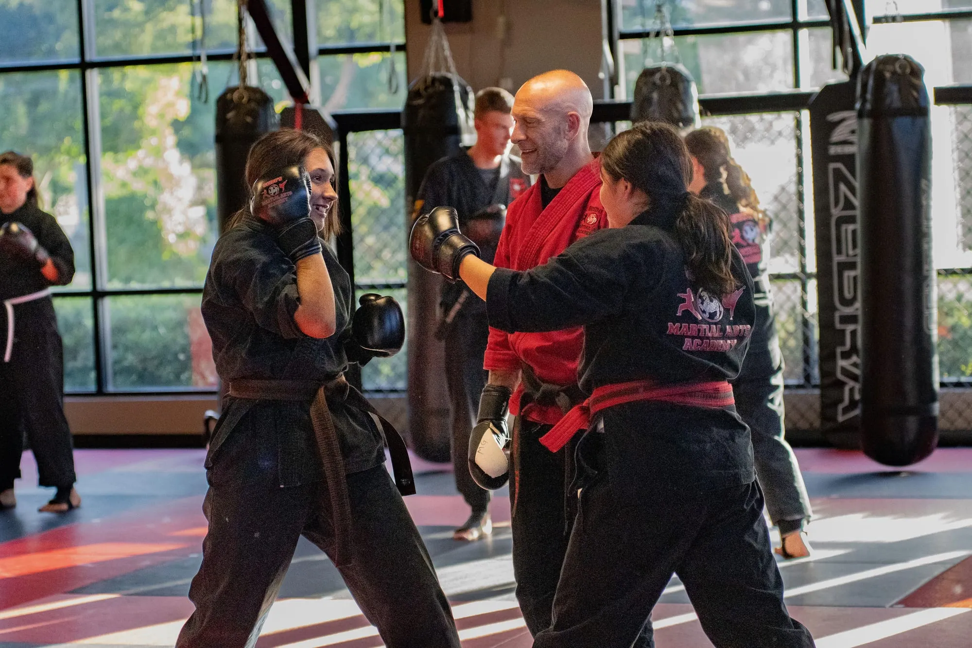 Shihan Mike Guido coaching adult students during partner pad work at Guido's Martial Arts Academy in Clovis, CA