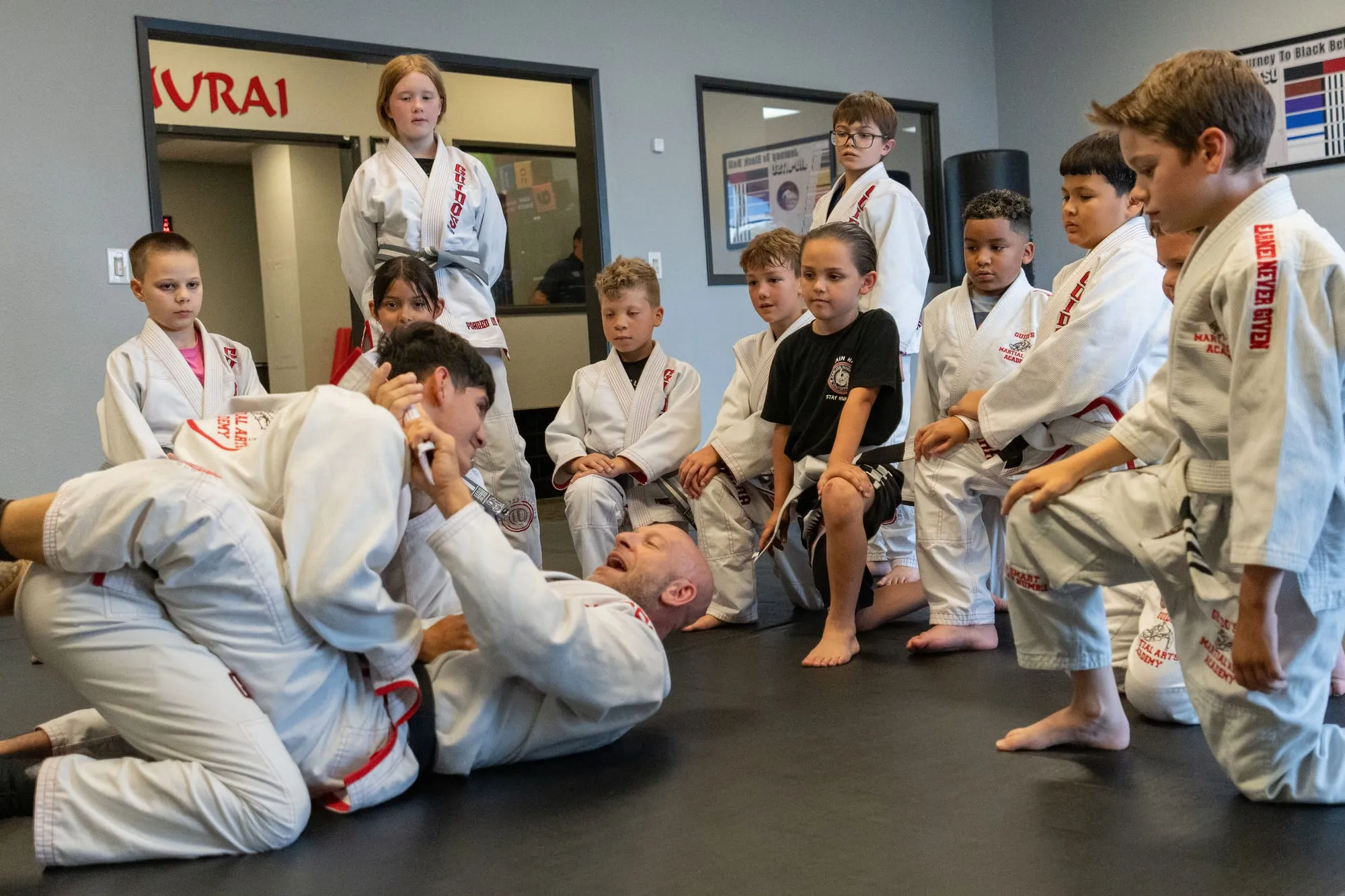 Shihan Mike Guido teaching a group of Juniors BJJ students on the mat at Guido's Martial Arts Academy in Clovis, CA
