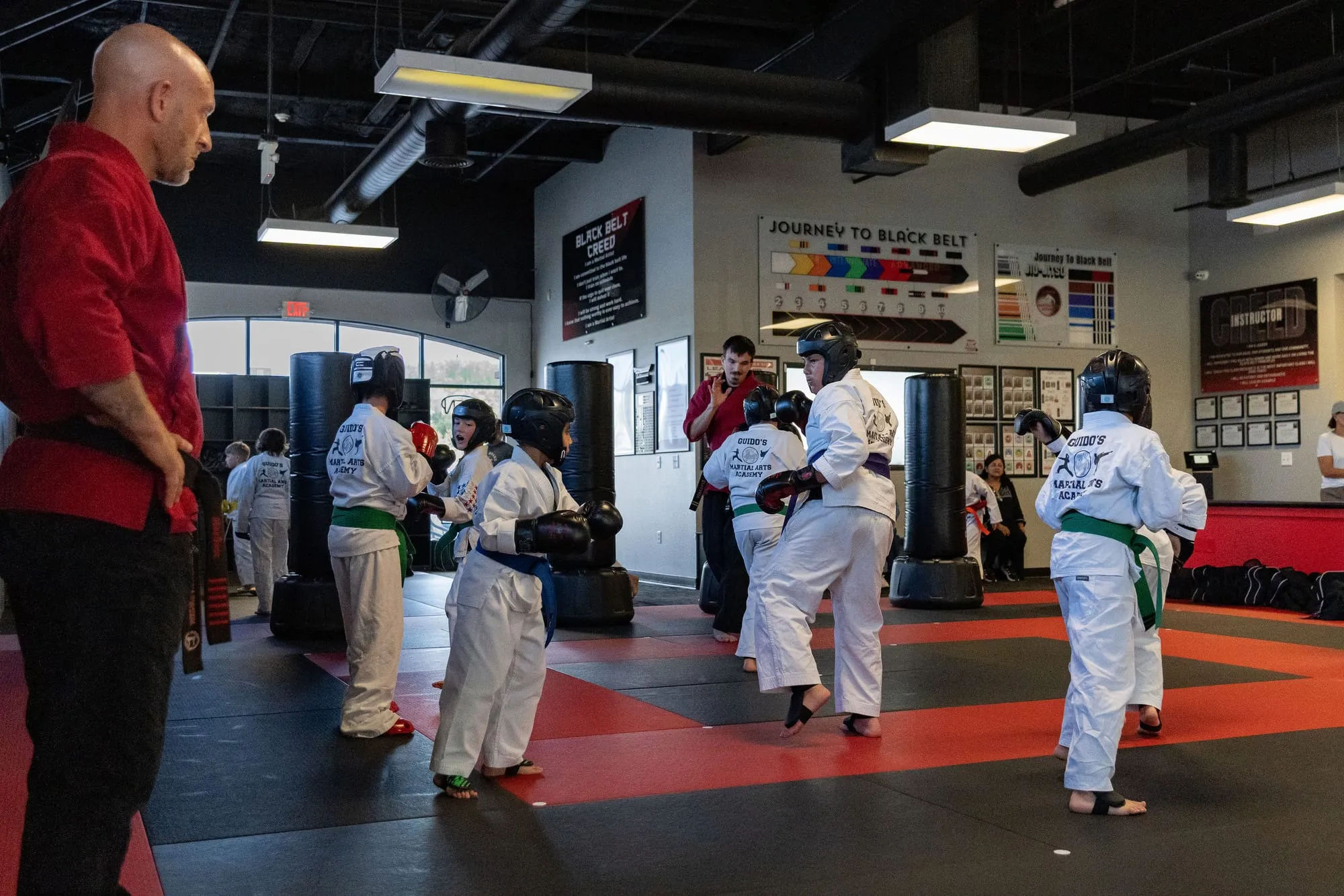 Juniors MMA instructor coaching a group of students during sparring drills at Guido's Martial Arts Academy in Clovis, CA