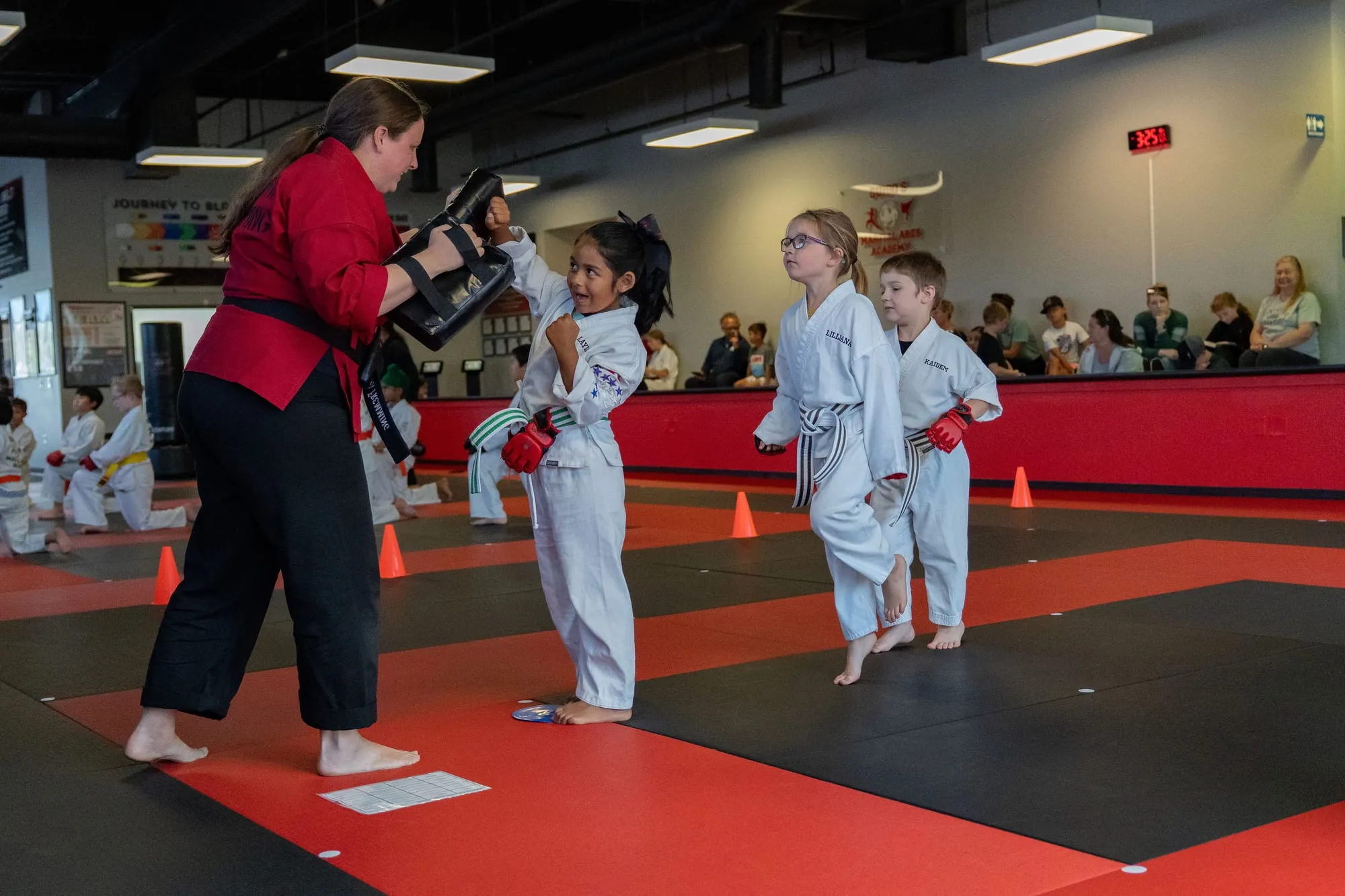Three smiling Big Ninjas students with orange belts at Guido's Martial Arts Academy in Clovis