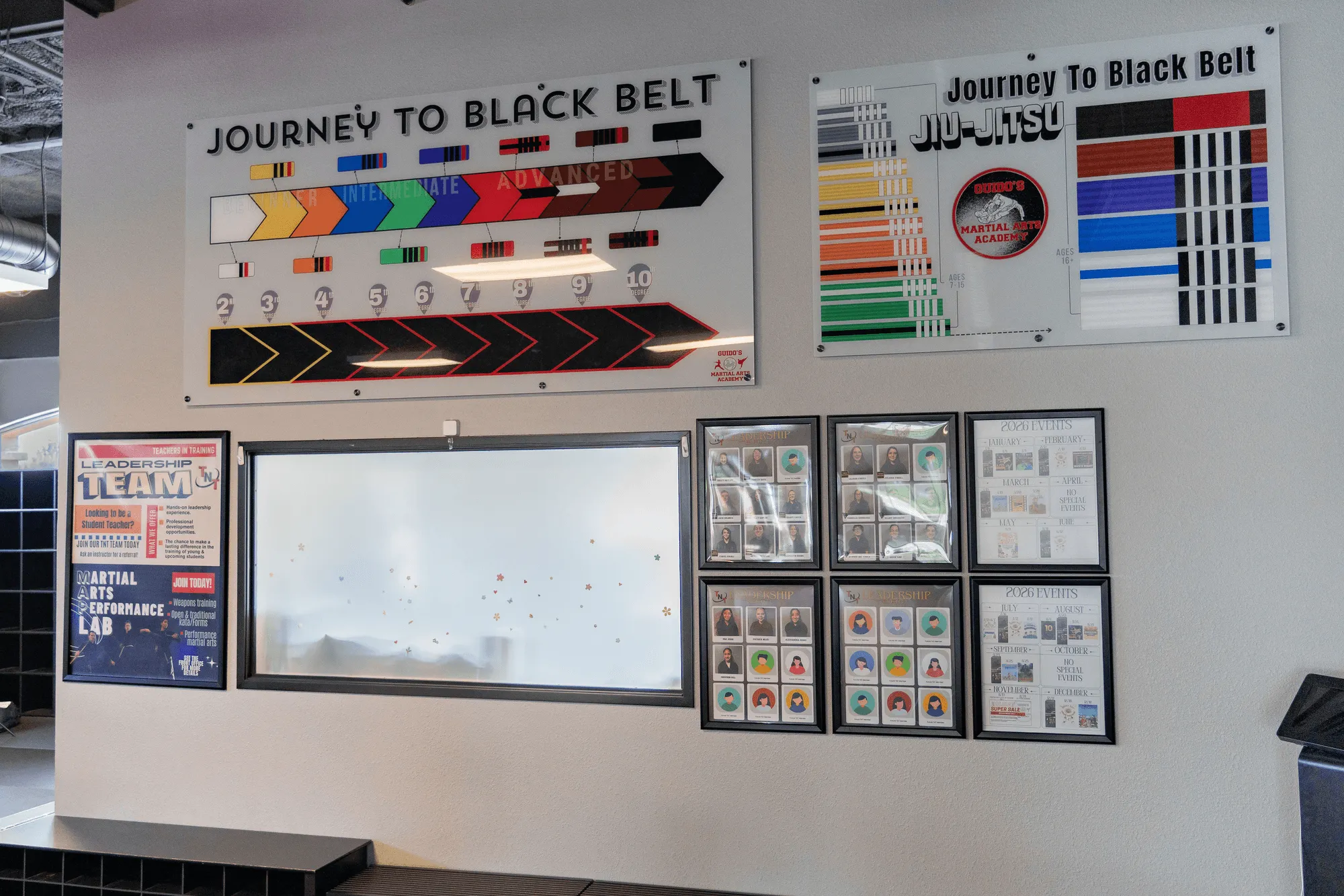 Belts in rank order on a wooden wall rack at Guido's Martial Arts Academy in Clovis, CA