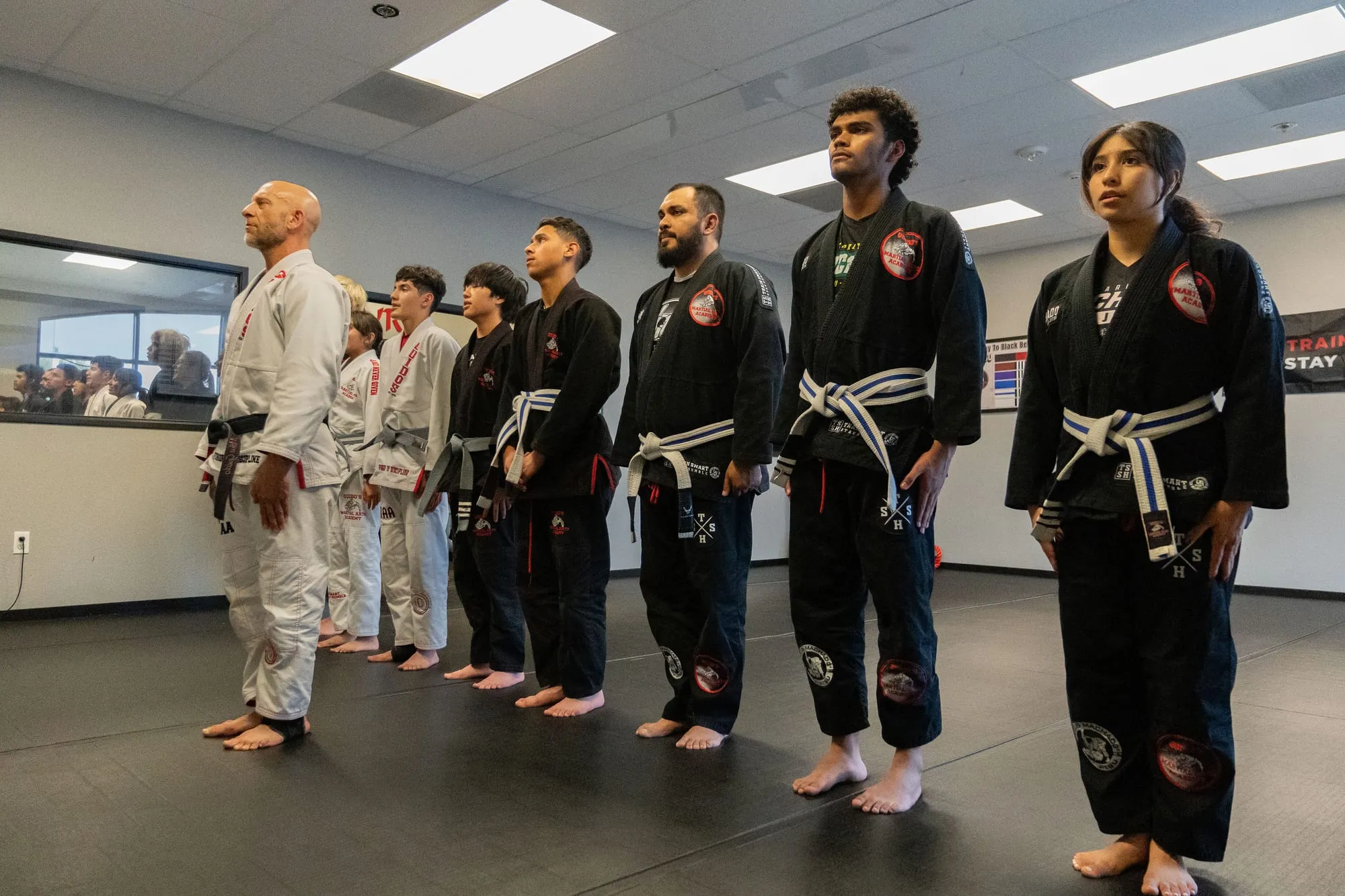 Adult Brazilian Jiu-Jitsu students lined up in gi inside the dojo at Guido's Martial Arts Academy in Clovis, CA