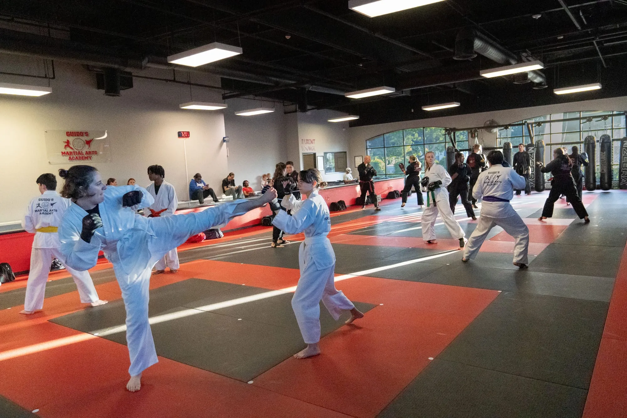 Teen and adult students training during a Mixed Martial Arts class at Guido's Martial Arts Academy in Clovis, CA