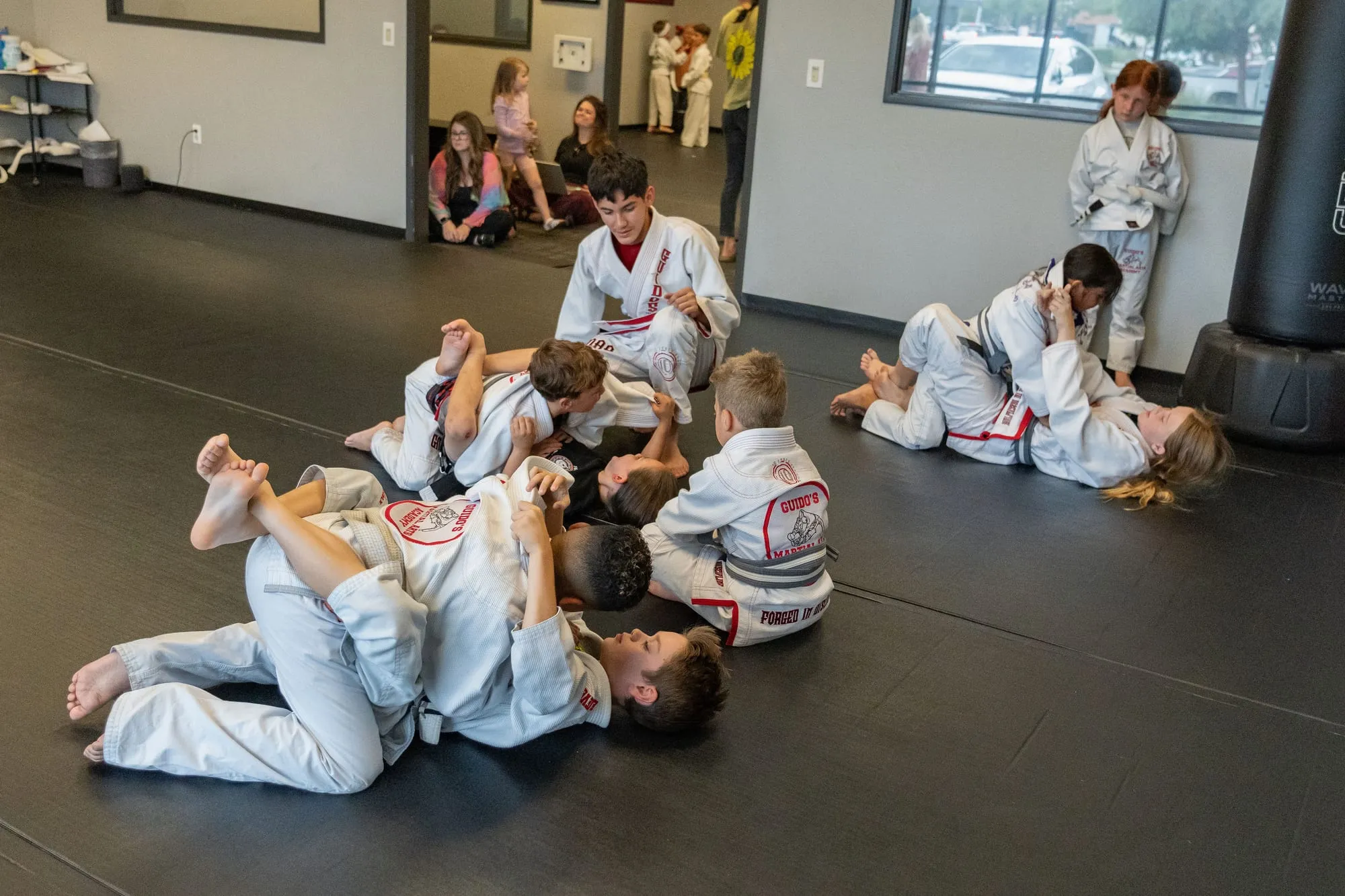 Juniors BJJ students rolling during class at Guido's Martial Arts Academy in Clovis, CA
