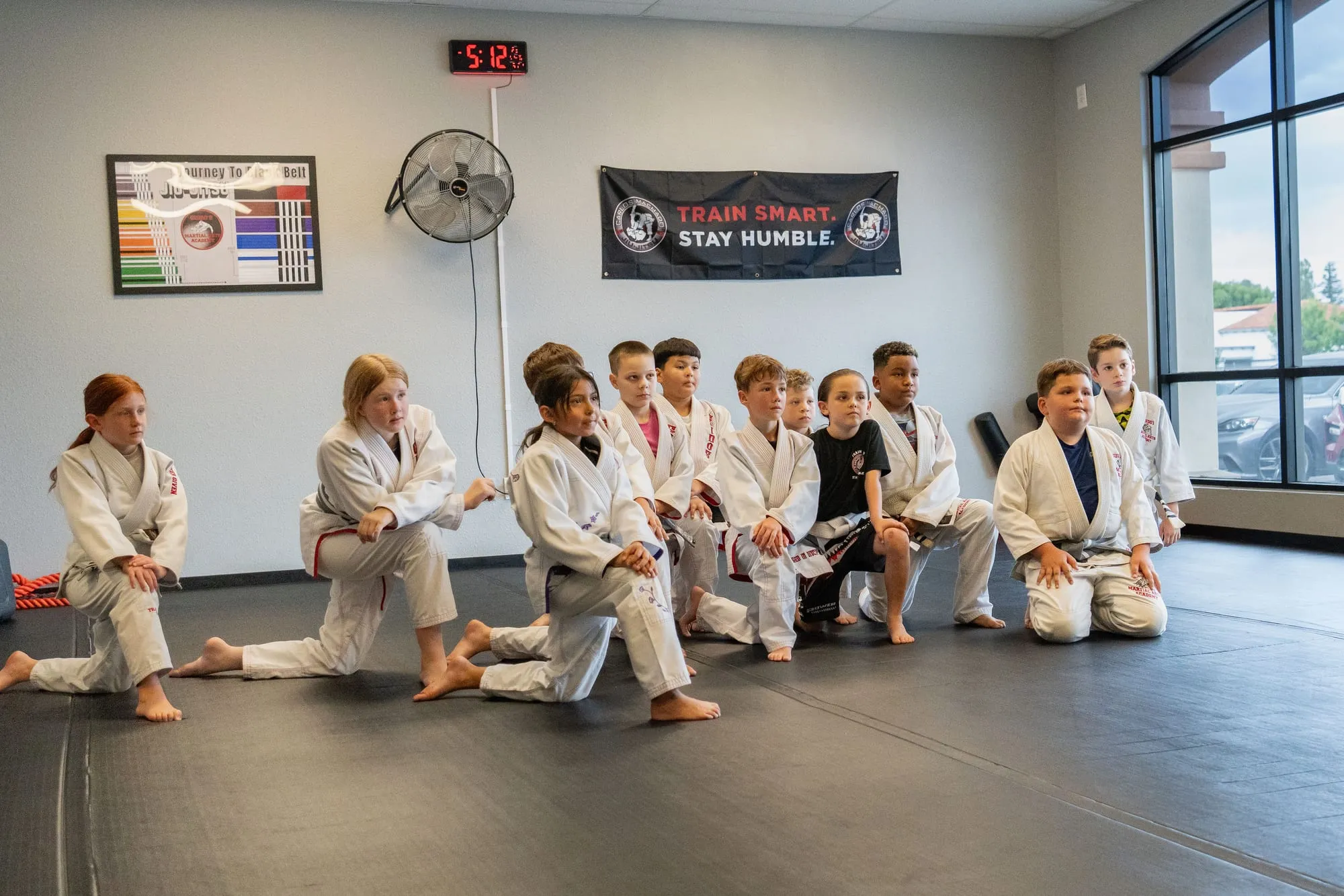 Juniors MMA student receiving a belt promotion at Guido's Martial Arts Academy in Clovis, CA