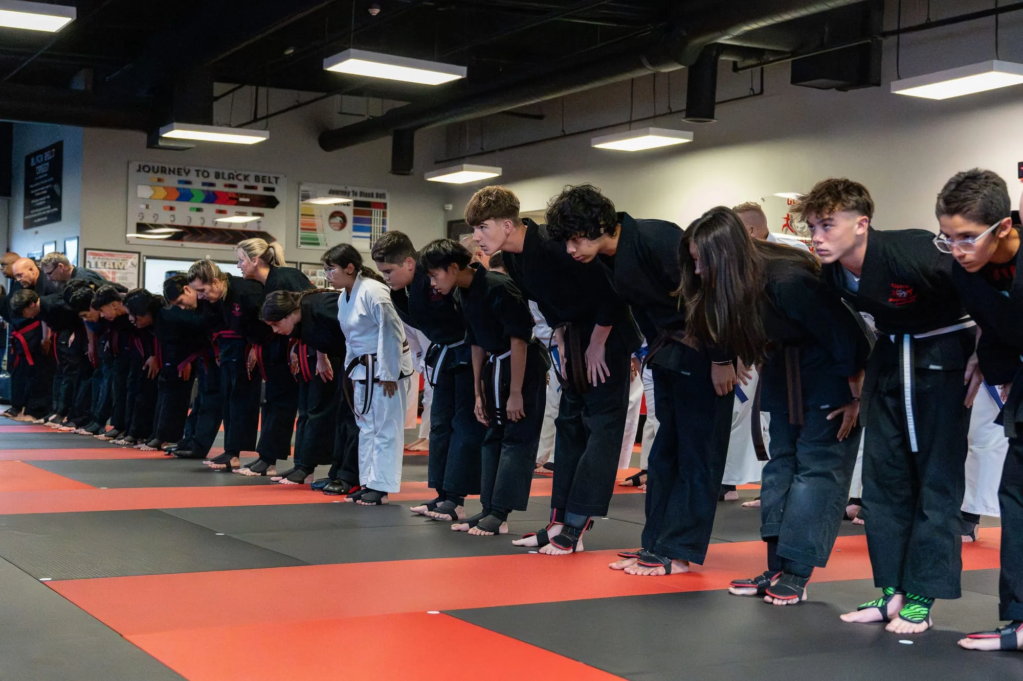 Juniors MMA students lined up and bowing in at the start of class at Guido's Martial Arts Academy in Clovis, CA