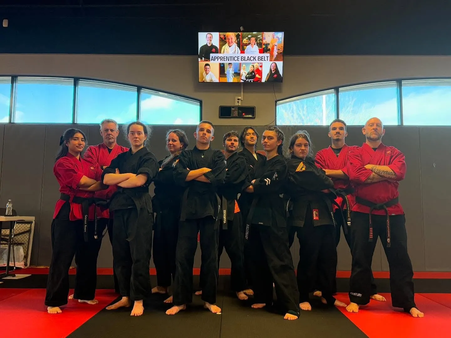Apprentice black belt students standing with their instructors on the mat at Guido's Martial Arts Academy in Clovis