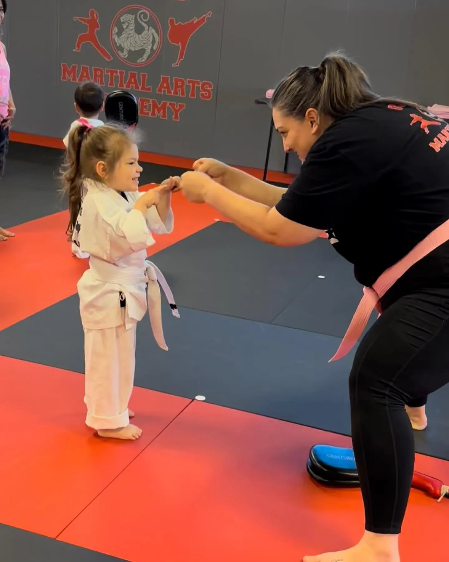A Guido's instructor working through a drill with a smiling young student in Clovis