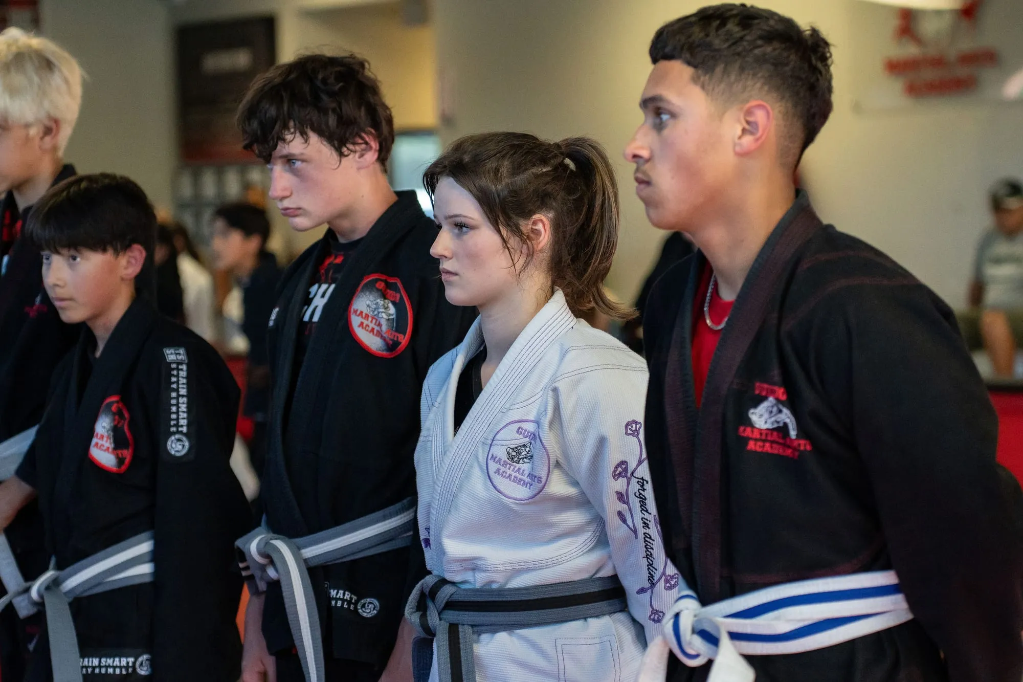 Teen and adult BJJ students lined up at the start of class at Guido's Martial Arts Academy in Clovis, CA