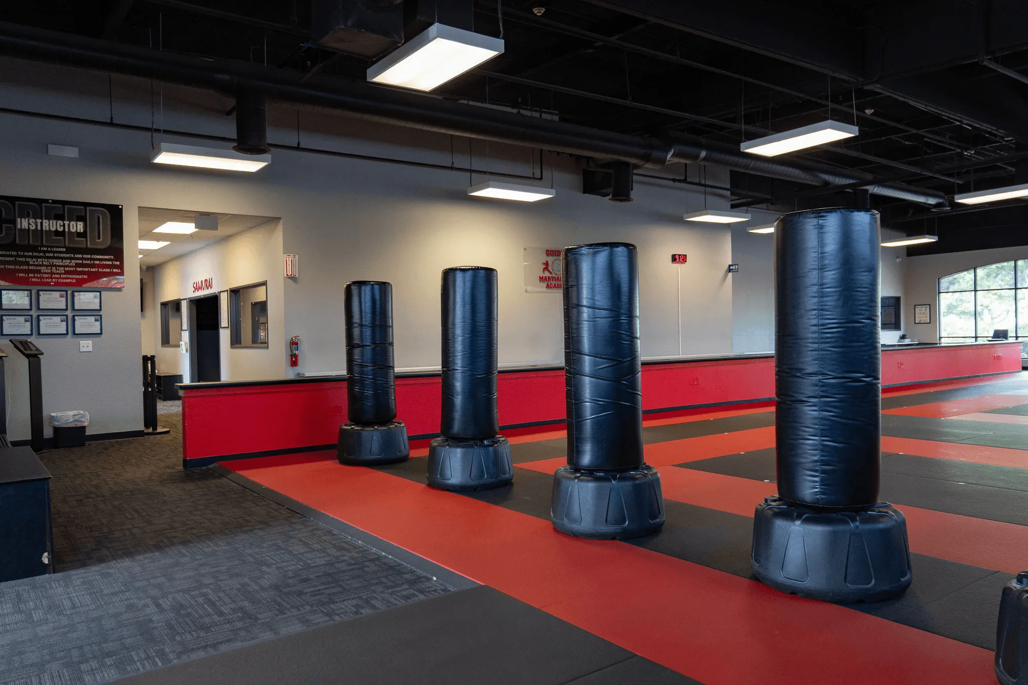 Hand wraps and a focus mitt resting on the dojo floor at Guido's Martial Arts Academy in Clovis, CA