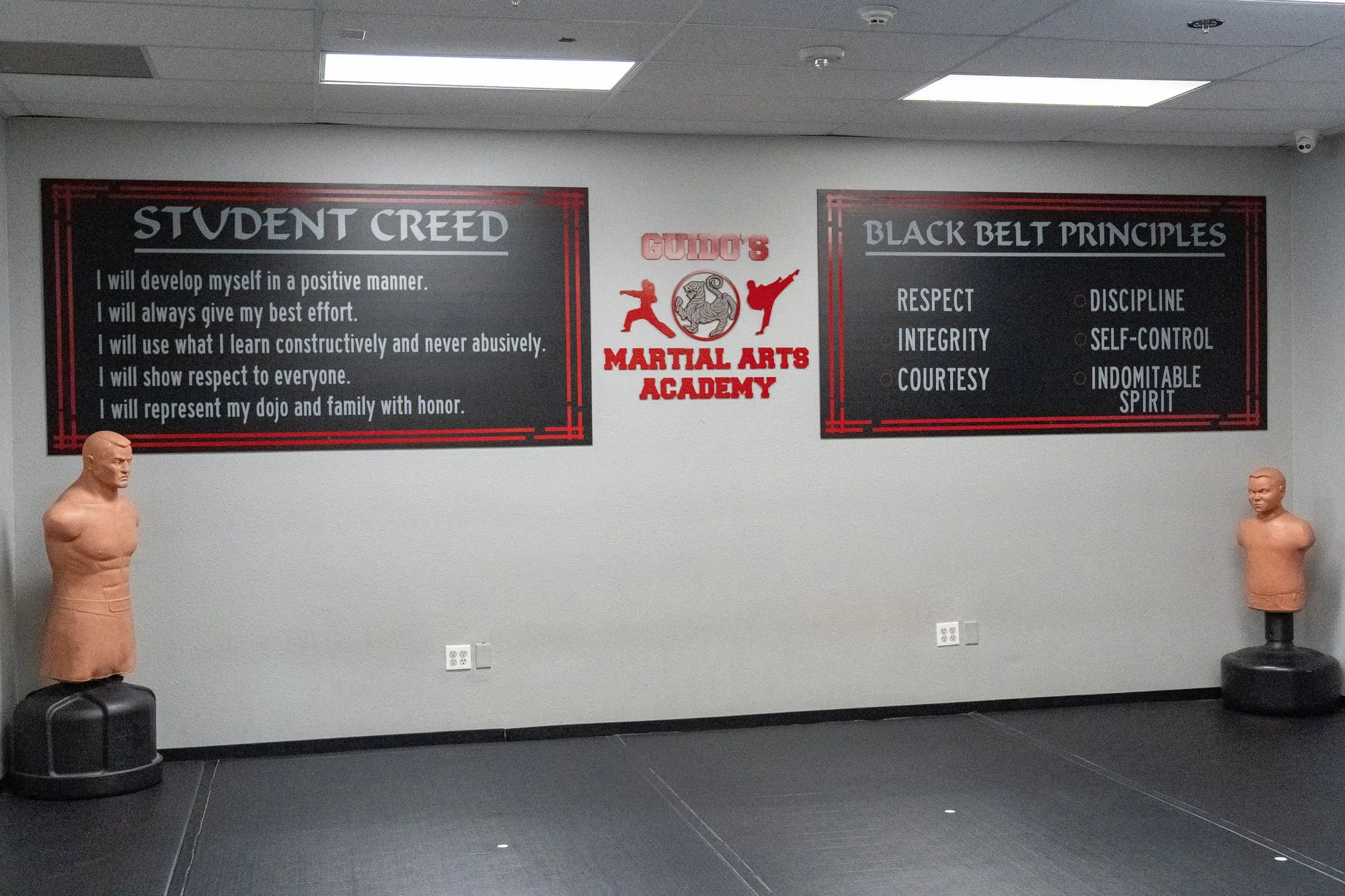 The Student Creed and Black Belt Principles displayed on the training-floor wall at Guido's Martial Arts Academy in Clovis