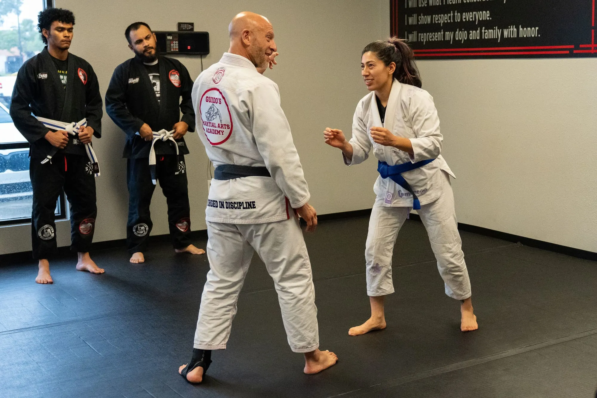 Shihan Mike Guido teaching a woman a self-defense stance during a Brazilian Jiu-Jitsu class at Guido's Martial Arts Academy in Clovis